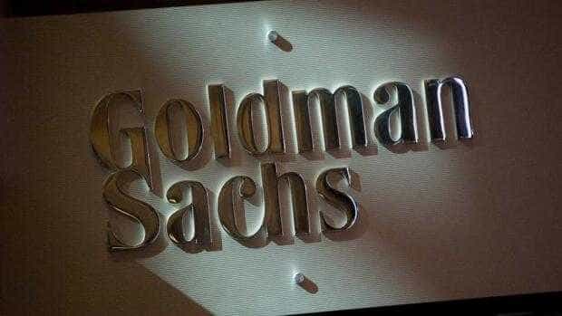 The Goldman Sachs & Co. logo is displayed at the company's booth on the floor of the New York Stock Exchange (NYSE) in New York, U.S., on Friday, July 19, 2013. U.S. stocks fell after benchmark equities gauges rose to records yesterday, after disappointing earnings from Google Inc. and Microsoft Corp. overshadowed better-than-forecast results from General Electric Co. Photographer: Scott Eells/Bloomberg via Getty Images