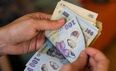 Details with the hands of a young lady counting banknotes of 50 and 100 Romanian Lei currency