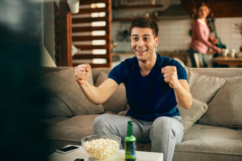 young-excited-man-watching-sports-match-tv-home